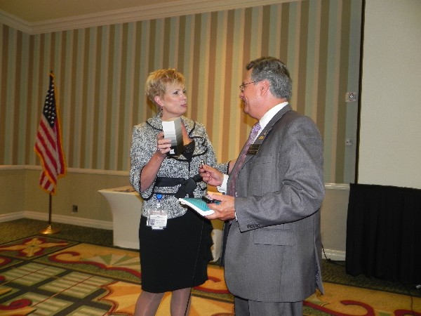 Dr. Ruben Garcia, district director, U.S. Small Business Administration, San Diego District Office, meets with Shirley Adams at the October luncheon.